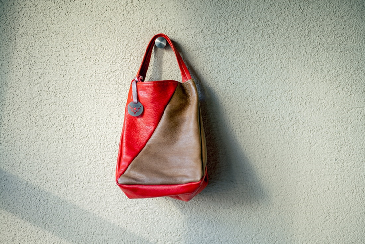 Takase’s most successful products have been her line of handbags, which feature her trademark design centered on rugged elegance, mixed with popping colors, primarily red and blue but also a multitude of brown tones. 